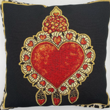 Decorative pillow with a red heart design on a black background